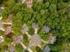 Aerial view shows a home among lush greenery in a well-established neighborhood at 3801 Stonebriar Ln, Duluth, GA 30097