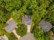 Aerial view showcases a home with a driveway surrounded by lush greenery and mature trees at 3801 Stonebriar Ln, Duluth, GA 30097