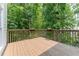 Large wooden deck with peaceful views of surrounding trees and foliage at 3801 Stonebriar Ln, Duluth, GA 30097