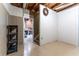 Unfinished basement includes a door, shelving, stairwell, and concrete walls at 3801 Stonebriar Ln, Duluth, GA 30097