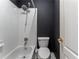 Cozy bathroom featuring a toilet, bathtub, white tiled walls, and a shower head at 3801 Stonebriar Ln, Duluth, GA 30097