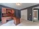 Home office features a dark accent wall, white carpets, desk, and closet at 3801 Stonebriar Ln, Duluth, GA 30097