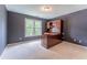 Cozy bedroom features a large window, neutral carpet, and desk with shelving at 3801 Stonebriar Ln, Duluth, GA 30097