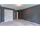 Carpeted bedroom with gray walls, white trim, and closet at 3801 Stonebriar Ln, Duluth, GA 30097