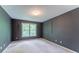 A standard carpeted bedroom with gray walls and a window with view to the outside at 3801 Stonebriar Ln, Duluth, GA 30097