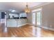 Bright breakfast area with hardwood floors, charming light fixture, and open layout with kitchen at 3801 Stonebriar Ln, Duluth, GA 30097