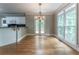 Eat-in kitchen area featuring hardwood floors, decorative lighting, and access to an outdoor balcony at 3801 Stonebriar Ln, Duluth, GA 30097
