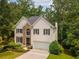 Two-story home with a stone facade, black shutters, and a manicured lawn at 3801 Stonebriar Ln, Duluth, GA 30097