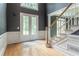 Foyer with staircase, hardwood floors, and a double glass door leading to the outside at 3801 Stonebriar Ln, Duluth, GA 30097