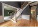 Foyer with white trim, wooden staircase, hardwood floors and dark gray walls at 3801 Stonebriar Ln, Duluth, GA 30097