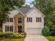 Charming two-story home with stone facade, black shutters, and well-manicured front yard at 3801 Stonebriar Ln, Duluth, GA 30097
