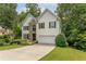 Inviting two-story home featuring a well-manicured lawn and a two-car garage at 3801 Stonebriar Ln, Duluth, GA 30097