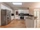 Updated kitchen with stainless steel refrigerator, granite countertops and tiled backsplash at 3801 Stonebriar Ln, Duluth, GA 30097