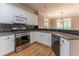 Kitchen featuring stainless steel appliances, granite countertops, tiled backsplash, and hardwood floors at 3801 Stonebriar Ln, Duluth, GA 30097