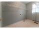 Laundry room features tile flooring, ample shelving, and a window with natural light at 3801 Stonebriar Ln, Duluth, GA 30097