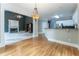 Open-concept living area with hardwood floors, a fireplace, and a kitchen with white cabinets at 3801 Stonebriar Ln, Duluth, GA 30097