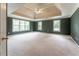 Generously sized main bedroom with tray ceilings, neutral paint, and multiple windows at 3801 Stonebriar Ln, Duluth, GA 30097