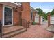 Charming brick patio leads to a covered entry and features a decorative fountain at 460 Chowning Nw Pl, Marietta, GA 30064