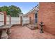 Inviting brick patio with fountain, table, and a well-maintained privacy fence at 460 Chowning Nw Pl, Marietta, GA 30064