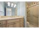 Bright bathroom featuring a vanity with cream cabinets and a shower with sliding glass doors at 460 Chowning Nw Pl, Marietta, GA 30064