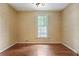 Bedroom with hardwood floors and neutral wallpaper, illuminated by natural light at 460 Chowning Nw Pl, Marietta, GA 30064