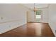 Bright dining room with hardwood floors and a traditional chandelier over a large window at 460 Chowning Nw Pl, Marietta, GA 30064