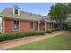 Charming brick home with manicured shrubs, a brick walkway, and a welcoming front porch at 460 Chowning Nw Pl, Marietta, GA 30064