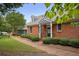 Appealing brick home featuring manicured landscaping, a brick walkway, and a cozy covered entrance at 460 Chowning Nw Pl, Marietta, GA 30064