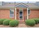 Charming brick home featuring a covered front porch and manicured landscaping at 460 Chowning Nw Pl, Marietta, GA 30064