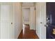 Hallway features hardwood floors, white trim, and doors at 460 Chowning Nw Pl, Marietta, GA 30064