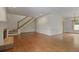 Spacious living room with hardwood floors and staircase featuring a chandelier in the corner at 460 Chowning Nw Pl, Marietta, GA 30064