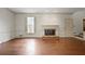 Bright living room features hardwood floors, a fireplace, and natural light from a window at 460 Chowning Nw Pl, Marietta, GA 30064