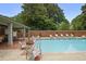 Tranquil community pool with surrounding foliage and lounge seating for a relaxing and serene atmosphere at 460 Chowning Nw Pl, Marietta, GA 30064