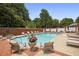 Relaxing community pool surrounded by lounge chairs and beautiful landscaping for a resort-like experience at 460 Chowning Nw Pl, Marietta, GA 30064