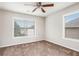 Bedroom with neutral carpet, ceiling fan, and natural light from two large windows at 726 Independence Ln, Acworth, GA 30102