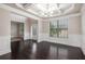 Dining area featuring hardwood floors, modern light fixture, wainscoting and a large window at 726 Independence Ln, Acworth, GA 30102