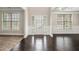 Elegant foyer boasting dark hardwood floors, windows, and decorative front door with ornate glass design at 726 Independence Ln, Acworth, GA 30102