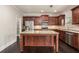 Well-appointed kitchen boasting granite countertops, stainless steel appliances, and a functional center island at 726 Independence Ln, Acworth, GA 30102