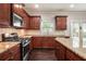 Kitchen featuring stainless steel appliances, granite countertops, and dark hardwood floors at 726 Independence Ln, Acworth, GA 30102