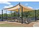 Community picnic area with wooden tables under a shaded awning and lush greenery in the background at 726 Independence Ln, Acworth, GA 30102