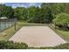 A sand volleyball court and a tennis court, nestled within a community with a backdrop of mature trees at 726 Independence Ln, Acworth, GA 30102