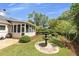 Lush backyard showcasing a fountain, decorative landscaping, and covered patio perfect for relaxation at 2265 Colony Dr, Canton, GA 30114