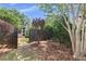 Backyard garden scene features a rustic fence, decorative foliage and ornate bench at 2265 Colony Dr, Canton, GA 30114
