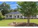 Charming single story home with well maintained lawn, mature trees and appealing stone bench at 2265 Colony Dr, Canton, GA 30114