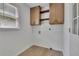 Laundry room with storage cabinets, shelves, and vinyl flooring at 2265 Colony Dr, Canton, GA 30114