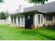 Well-maintained backyard features green lawn, neutral-colored siding, and sliding glass doors at 2350 Laurel Pointe Ln, Lawrenceville, GA 30043