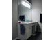 A bathroom featuring a double sink vanity with white cabinets and dark wood look flooring at 2350 Laurel Pointe Ln, Lawrenceville, GA 30043