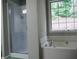 A bathroom featuring a walk-in shower, soaking tub, and a bright window at 2350 Laurel Pointe Ln, Lawrenceville, GA 30043