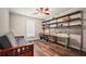 Versatile bedroom with wall shelves, futon, and natural light at 2350 Laurel Pointe Ln, Lawrenceville, GA 30043