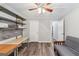A spacious bonus room featuring stylish gray walls, wood look flooring, and custom shelving at 2350 Laurel Pointe Ln, Lawrenceville, GA 30043